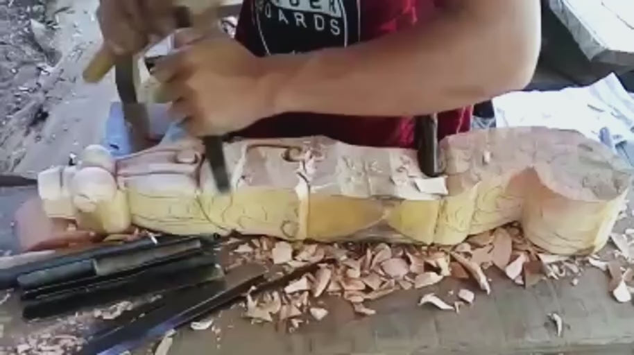 Defining the Curves — Careful cuts give the carved frame its flowing lines and depth.