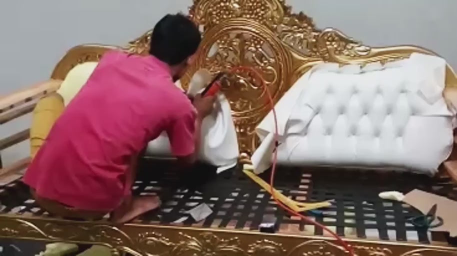 Fitting the Tufted Back — Upholstery is fitted to the carved frame as the seating comes together.